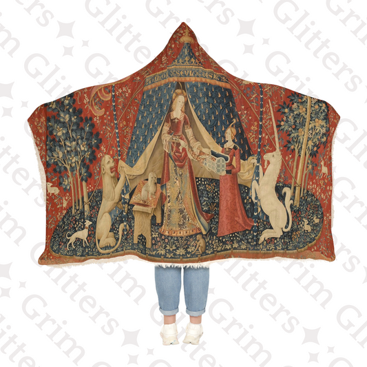 Wrap yourself in the enchanting beauty of The Lady and the Unicorn (Desire) Snuggle Cloak from Grim Glitters. Inspired by the iconic medieval tapestry.